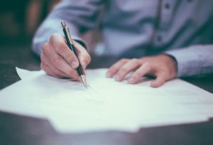 Man filling out purchase order documents