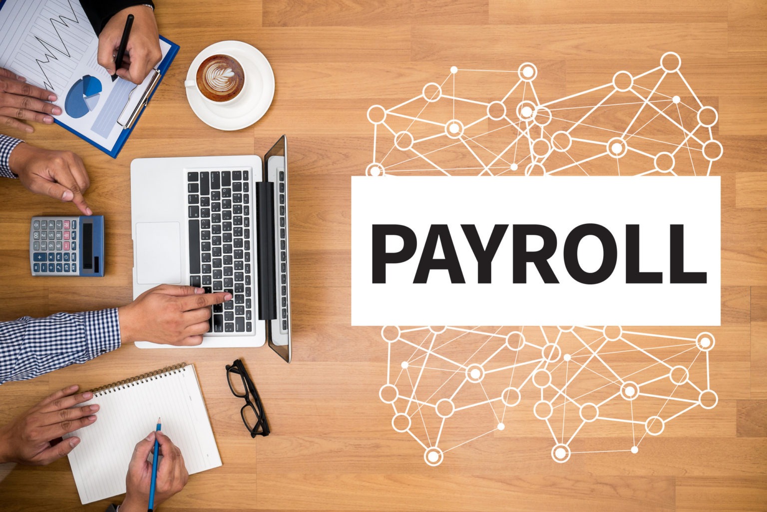 Business owner reviewing payroll documents on a laptop – payroll funding concept.