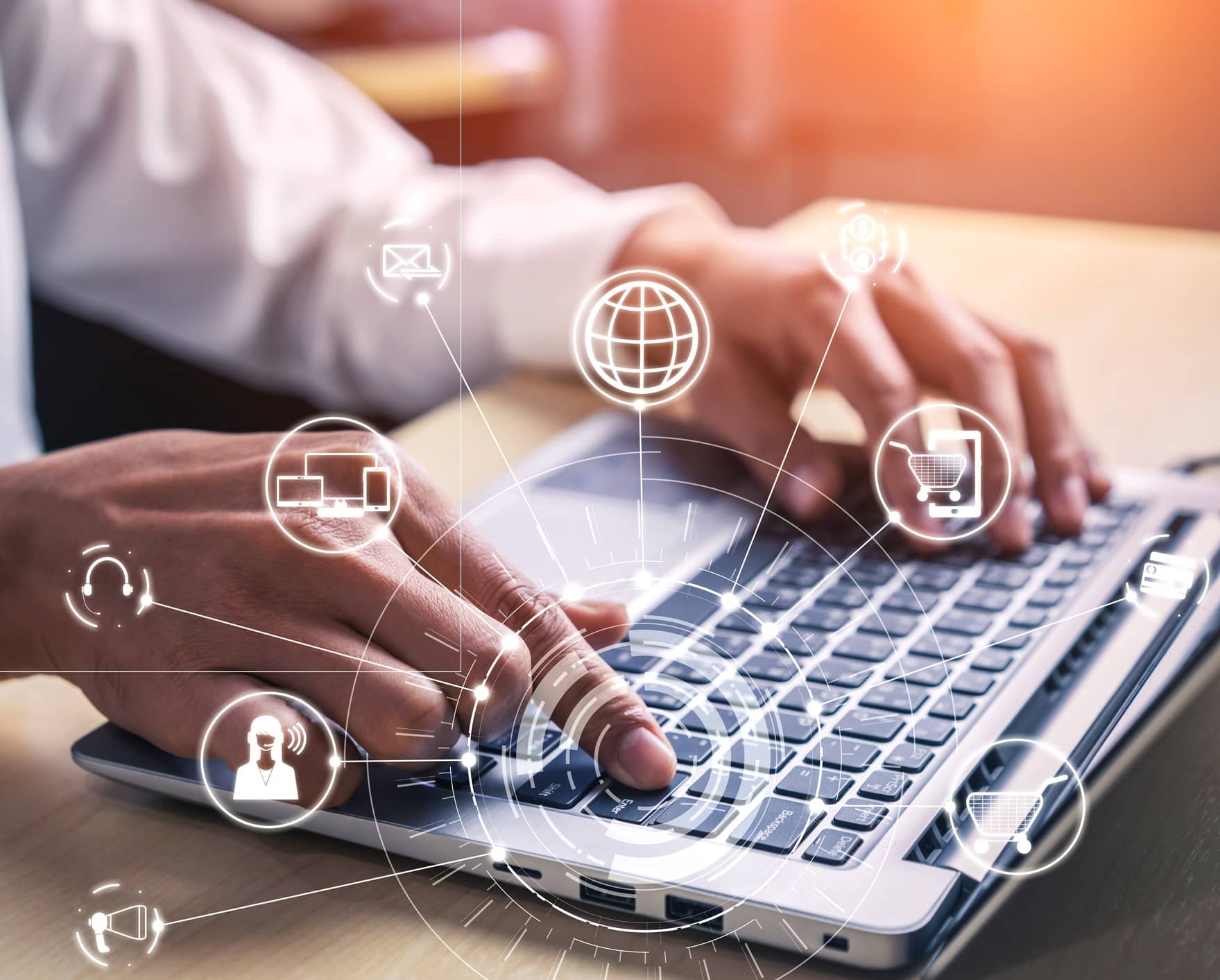Hands typing on a laptop with digital interface icons overlay