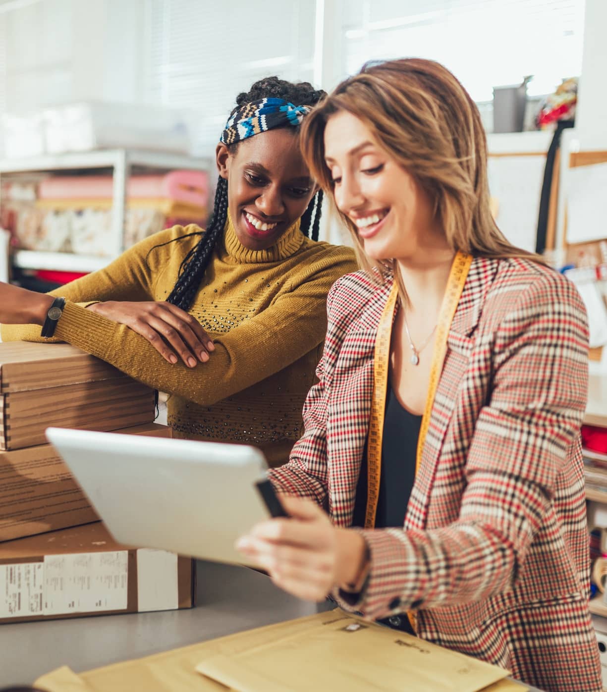 two ladies logging into their merchant services account two ladies logging into their merchant services account
