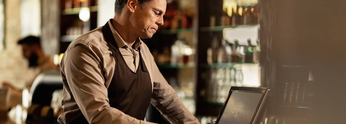 man entering a POS transaction into his Clover POS system