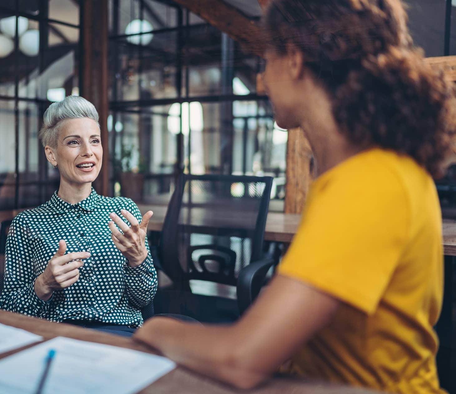 two people discussing group health insurance plans and employee benefits packages