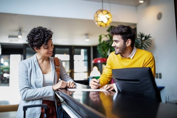 Businesswoman and consultant discussing documents at a counter in a modern office