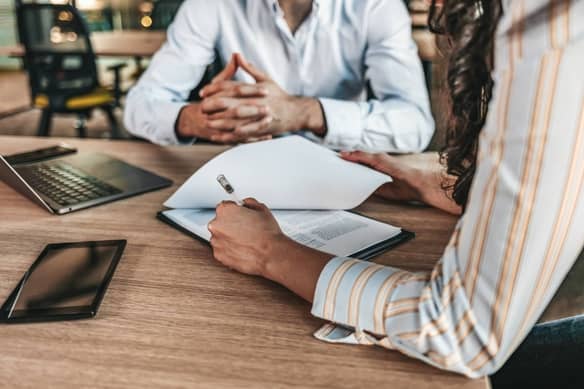 Business team reviewing loan documents together at a conference table